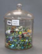 A Meredith and Drew Biscuits glass jar and cover containing Victorian and later coloured marbles,