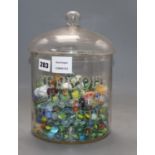 A Meredith and Drew Biscuits glass jar and cover containing Victorian and later coloured marbles,
