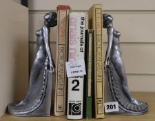 A pair of silvered resin bookends and four books: The Journals of Anais Nin, Under The Hill,