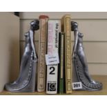 A pair of silvered resin bookends and four books: The Journals of Anais Nin, Under The Hill,