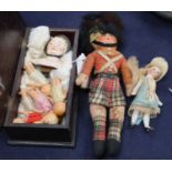 A German double sided pin doll head and seven other small dolls
