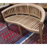 A teak garden 'banana' bench, L.160cm, D.53cm, H.62cmCONDITION: New condition