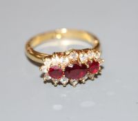 A modern yellow metal, ruby and diamond set triple cluster ring, with expanding shank, size 0-R,