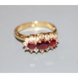 A modern yellow metal, ruby and diamond set triple cluster ring, with expanding shank, size 0-R,