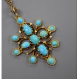 An early 20th century yellow metal and turquoise set pendant, on a yellow metal chain, pendant