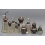 Ten assorted silver or white metal mounted glass atomisers and scent bottles and a white metal