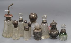 Ten assorted silver or white metal mounted glass atomisers and scent bottles and a white metal