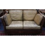 A small vintage two seater Knowle settee upholstered in studded pale brown leather, W.156cm, D.88cm,