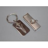 A modern silver concord key ring and a silver mounted cigar cutter.