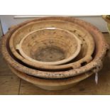 Four circular terracotta garden dishes, largest diameter 60cm