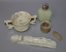 A Chinese jade belt hook, an archer's ring and figure, a stone cup and a glass snuff bottle