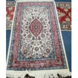 A Persian style ivory ground rug, 155 x 95cm