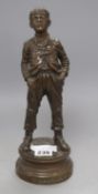 A bronze figure of a boy, 'Siffleur', with plaque titled Par Hertzberg, Exposition de 1889, height