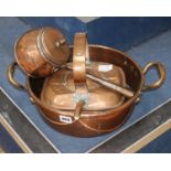 A Victorian copper two handled preserve pan, a copper lidded saucepan and four other pieces