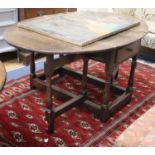 An 18th century oak oval topped gateleg dining table, 150cm extended, W.100cm, H.68cm