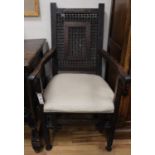 A North African carved hardwood armchair, W.55cm., D.42cm., H.105cm.CONDITION: Missing spindles to