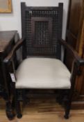A North African carved hardwood armchair, W.55cm., D.42cm., H.105cm.CONDITION: Missing spindles to