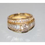 A modern yellow metal and three row diamond set dress ring, size J, gross 7 grams, set with round