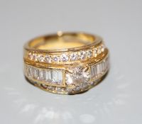 A modern yellow metal and three row diamond set dress ring, size J, gross 7 grams, set with round