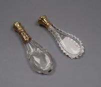 Two 19th century French yellow metal mounted cut glass scent bottles, largest 12.2cm, both lacking