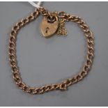 An early 20th century 9ct curblink bracelet with heart shaped clasp, gross 10.8 grams.