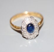 A modern 18ct gold and plat, sapphire and diamond oval cluster ring, size L, gross 2.6 grams.