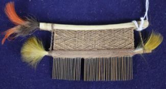 A Hixkaryana Amazonian Indian cotton-wrapped cane comb, with a bird-bone top, feather danglers,