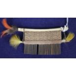 A Hixkaryana Amazonian Indian cotton-wrapped cane comb, with a bird-bone top, feather danglers,