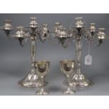 A pair of continental 900 standard white metal candelabra(a.f.) height 34cm and a pair of sterling