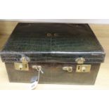 A crocodile skin travelling toilet case, containing silver topped glass jars, case 45.5cm