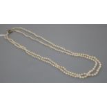 A double strand graduated cultured pearl necklace, with sapphire and diamond set white metal