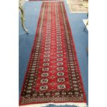 A Bokhara red ground runner, 375 x 85cm