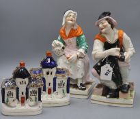 A pair of large Staffordshire pottery figures of the cobbler and his wife and a pair of