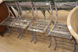 Four Victorian cast iron slatted garden chairs