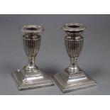 A pair of late Victorian silver dwarf candlesticks, Samuel Smith, London, 1899, 12cm, weighted.