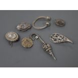 A silver Celtic style brooch and six other silver or white metal items of jewellery.