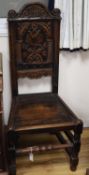 A pair of carved oak panel-back chairs