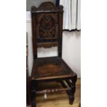 A pair of carved oak panel-back chairs