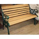 A Victorian style slatted green painted cast metal garden bench, W.130cm, D.66cm, H.76cm