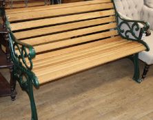 A Victorian style slatted green painted cast metal garden bench, W.130cm, D.66cm, H.76cm