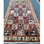A Persian Garden rug, red, blue and ivory ground with bird and flower motifs, 305 x 169cm