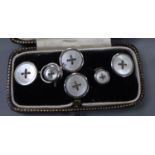 A white metal (stamped 9ct) and mother of pearl set six piece dress stud set, gross weight 6.3