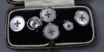 A white metal (stamped 9ct) and mother of pearl set six piece dress stud set, gross weight 6.3