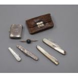 A silver vesta case, three silver fruit knives, a silver mounted leather purse, a silver penknife