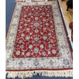 A Tabriz red ground rug, 185 x 120cm