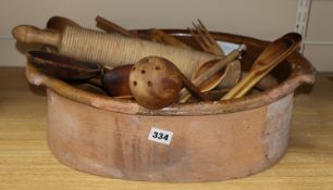 A terracotta bowl, a pill roller and a collection of wood spatula's, forks, spoons, etc,