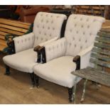 A pair of late Victorian ebonised armchairs upholstered in buttoned fabric