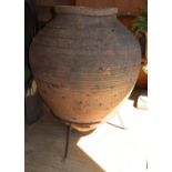 A large earthenware olive jar garden pot on stand, H.115cm