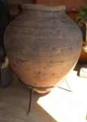 A large earthenware olive jar garden pot on stand, H.115cm