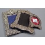Three assorted Edwardian repousse silver mounted photograph frames, largest 23.1cm.CONDITION: The